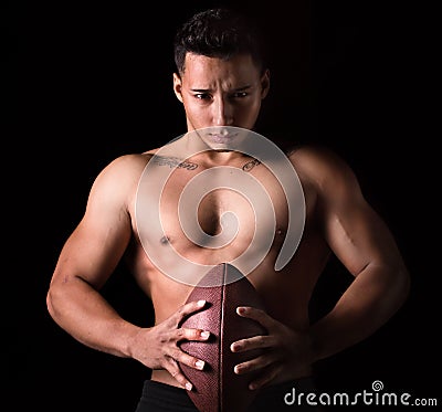 Football player holding a ball in his hands Stock Photo